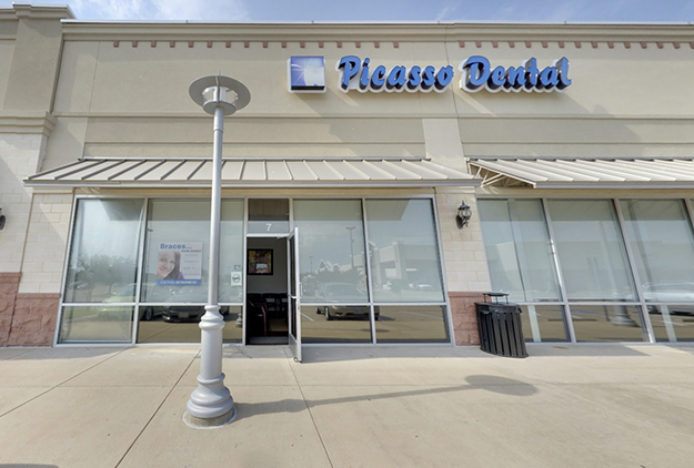 Picasso Dental storefront exterior with glass doors and windows in shopping plaza